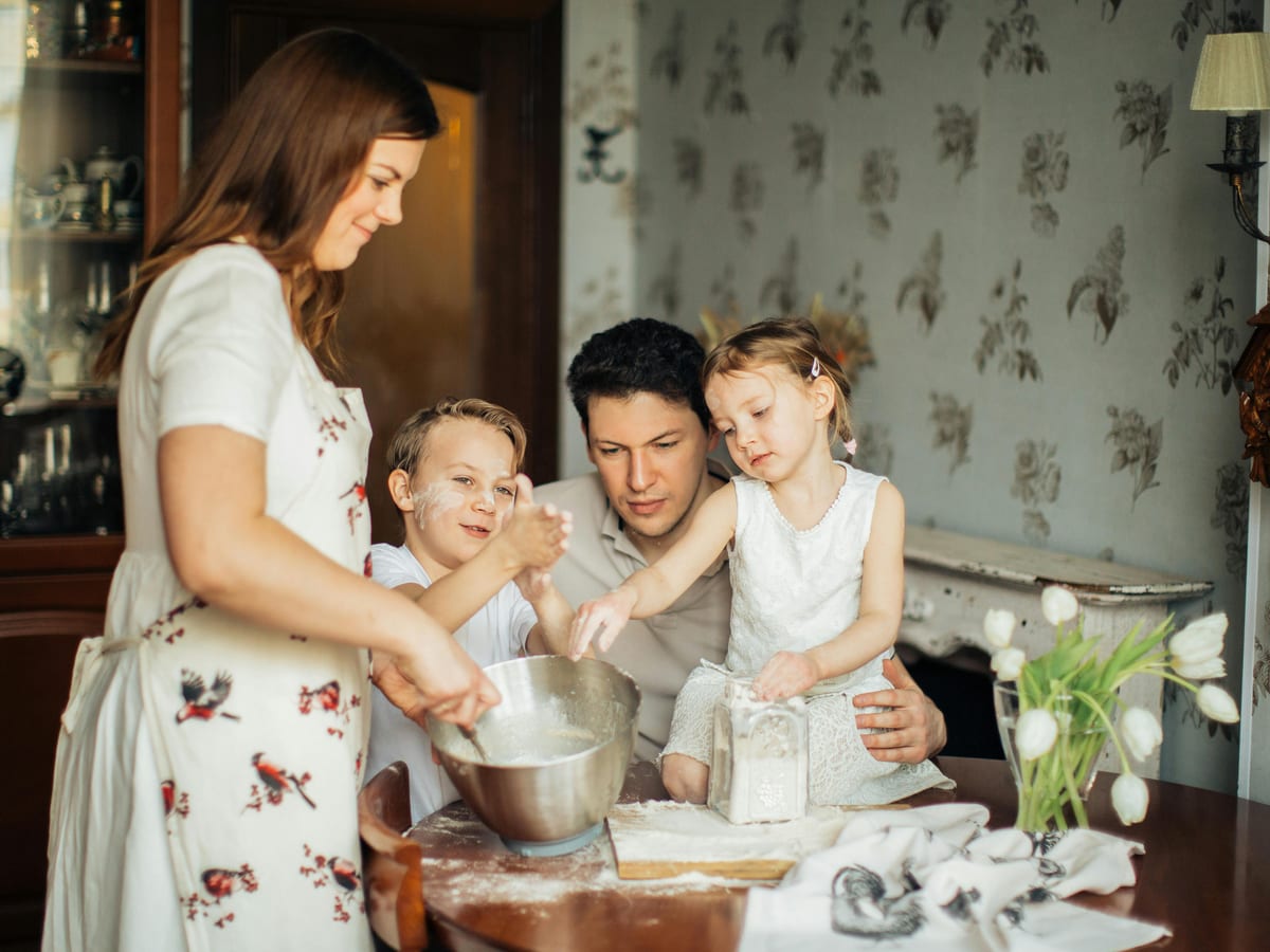 Older couple sitting together at home reviewing documents in warm natural light