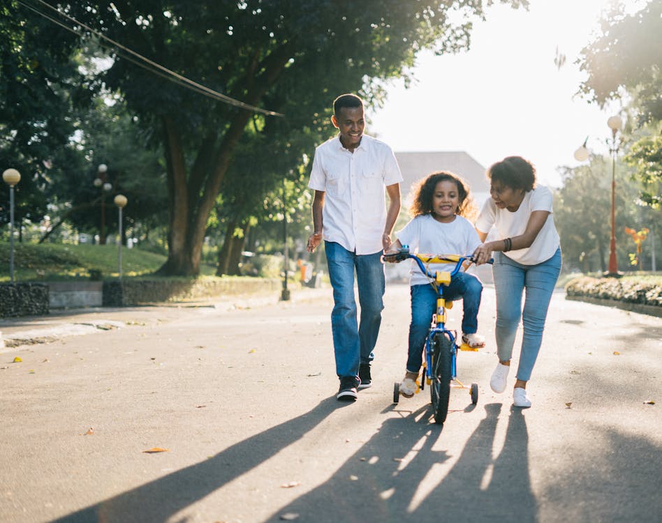 Multigenerational family gathered together outdoors, arms around each other