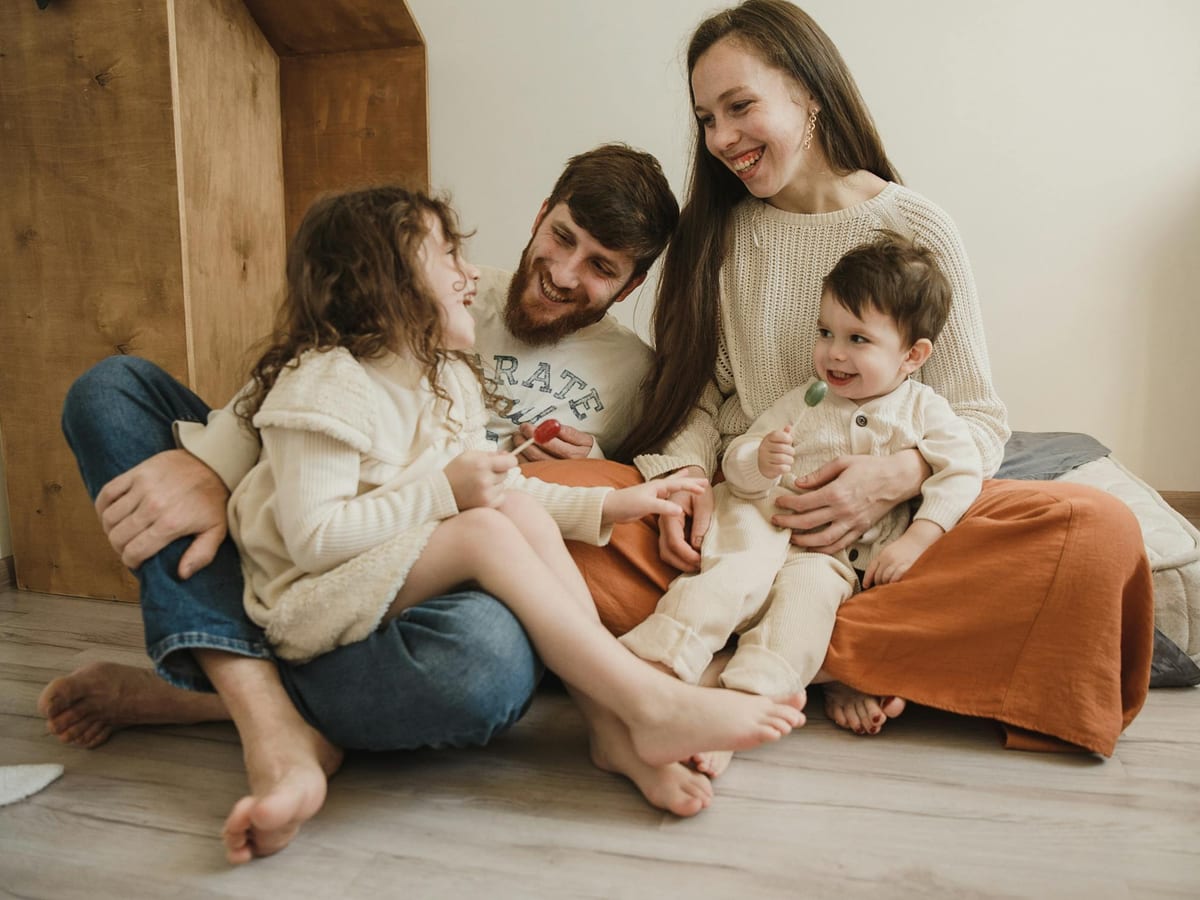 Retired man reviewing monthly household bills and a coin jar beside a notebook